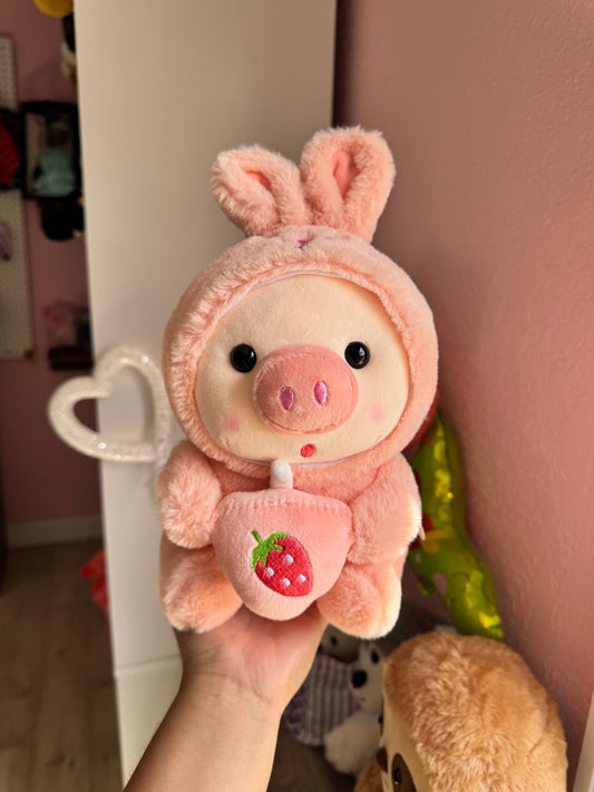 Baby pig in costume with bubble tea